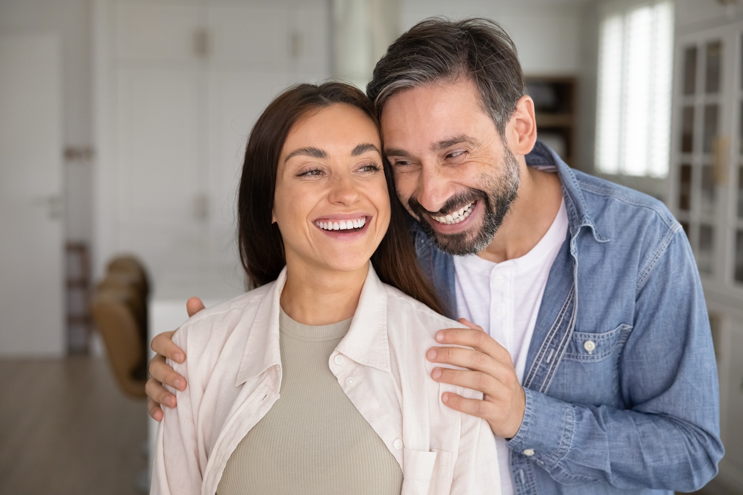 Smiling couple at home with bright healthy smiles, representing dental care from a San Diego dentist serving the La Mesa community